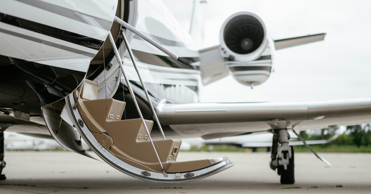 Private jet stairway going up to the plane