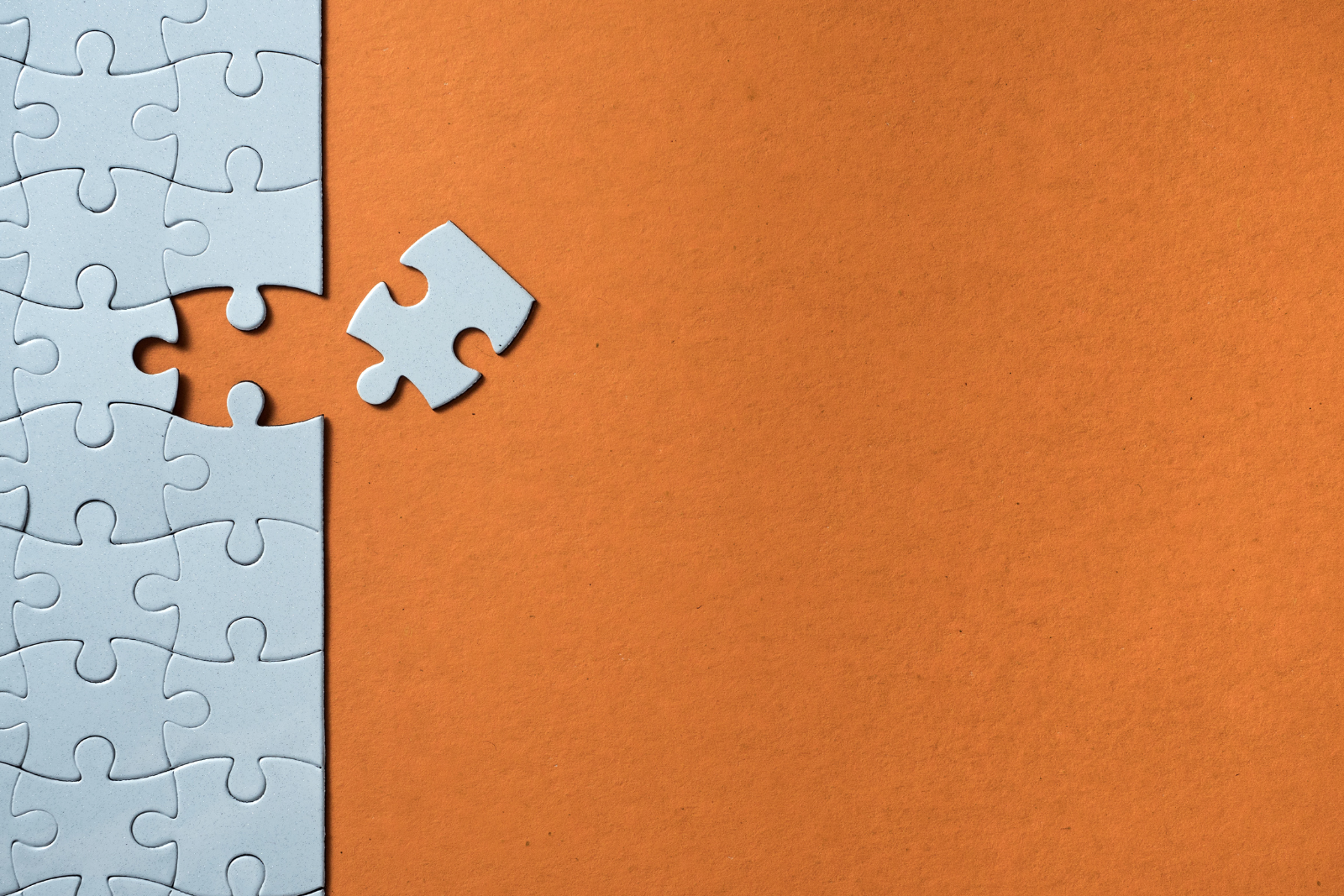 Image of a missing puzzle piece with an orange background